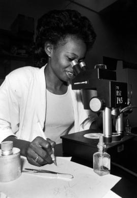 Woman uses a microscope in a laboratory, St. Cloud State University