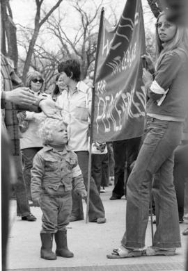 A boy stands among protestors, Day of Peace protest, St. Cloud State University