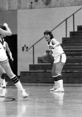 Dawn Anderson dribbles a basketball during a basketball game, St. Cloud State University