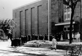 Graduates walk into Stewart Hall (1948) for commencement, St. Cloud State University