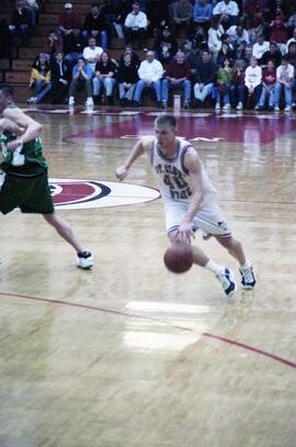 Jason Kron dribbles a basketball during a basketball game against the University of North Dakota, St. Cloud State University