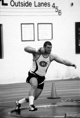 Travis Zins throws a shot put, St. Cloud State University
