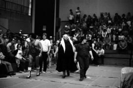 Wrestlers Sheik Adnan El Kaissey and Jerry Blackwell walk to the wrestling ring for their match at Halenbeck Hall (1965), St. Cloud State University
