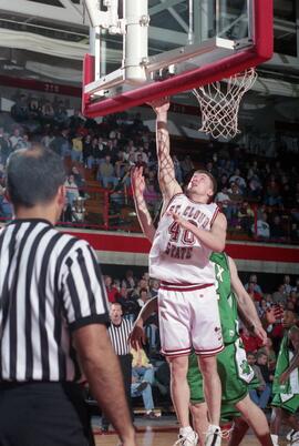 Jason Kron dunks a basketball during a game against the University of North Dakota