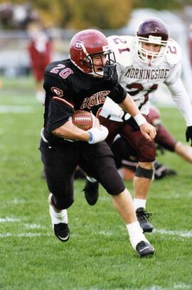 Randy Martin runs with a football during a game, St. Cloud State University