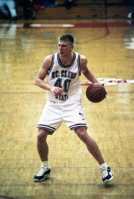 Jason Kron dribbles a basketball during  a basketball game against Morningside College, St. Cloud State University