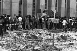 Protestors march on sidewalk, Day of Peace protest, St. Cloud State University