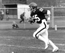 Football player runs with the football, St. Cloud State University