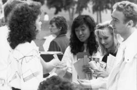 Students stand together at a vendor table, St. Cloud State University