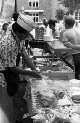 A man prepares food, Lemonade Concert and Art Fair, St. Cloud State University