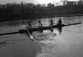 Rowing Club members row their boat on the Mississippi River, St. Cloud State University