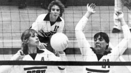 St. Cloud State University volleyball players Lisa Greve and Jeanne Burnett block the ball against the University of Minnesota-Morris