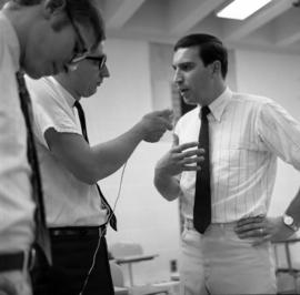 Mike Kobluk of the Mitchell Trio is interviewed by WJON's Mike Diem before their concert at Halenbeck Hall (1966), St. Cloud State University