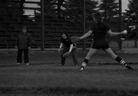 Woman softball player pitches the softball in a game against Winona State, St. Cloud State University