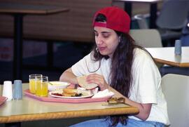 Woman eats at Garvey Commons (1963), St. Cloud State University