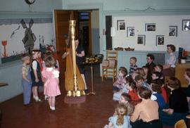 Children listen to a harp at Riverview, St. Cloud State University