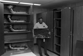 Kenton Frohrip holds a musical instrument case, St. Cloud State University