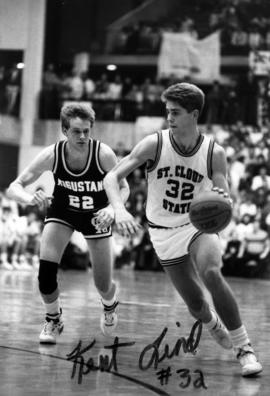 Basketball player Kent Lind dribbles a basketball during a game, St. Cloud State University