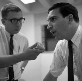 Mike Kobluk of the Mitchell Trio is interviewed by WJON's Mike Diem before their concert at Halenbeck Hall (1966), St. Cloud State University