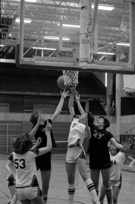 St. Cloud State basketball player Sue Wahl goes for a rebound during a game against University of Wisconsin-Eau Claire at Halenbeck Hall (1965)