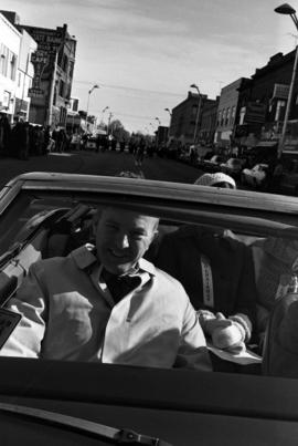 People ride in a car during the homecoming parade in downtown St. Cloud, St. Cloud State University