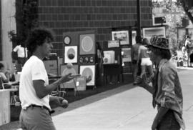 Two men juggle together, Lemonade Concert and Art Fair, St. Cloud State University