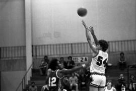 St. Cloud State University basketball player Dan Hagen shoots a basketball during a game against Marycrest College