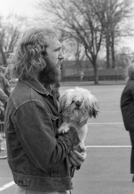 A man walks with his dog, Day of Peace protest, St. Cloud State University