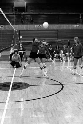 Volleyball player Sue Wahl hits a volleyball during a game against Southwest State University at Halebeck Hall (1965), St. Cloud State University