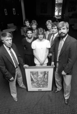 Former Atwood Memorial Center director Joe Basil accepts a painting from the family of Janelle Johnson, St. Cloud State University