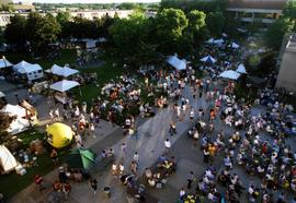 People gather on sidewalks to watch an orchestra perform, Lemonade Concert and Art Fair, St. Cloud State University