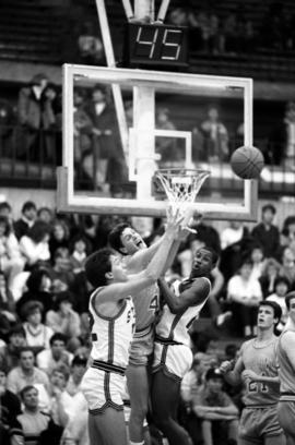 Mike Alapsa and Reggie Perkins try to get a rebound during a game against St. John's University, St. Cloud State University