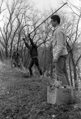 People pick up trash along the Mississippi River during Earth Day, St. Cloud State University