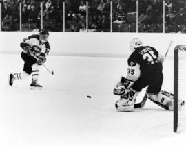 Hockey player Jeff Schmidt shoots the puck during a game, St. Cloud State University