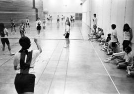 Women play volleyball in a gym, St. Cloud State University