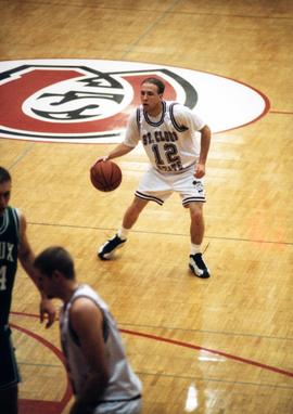 Zach Goring dribbling a basketball during a game, St. Cloud State University