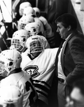 Herb Brooks talks to a hockey player during a game, St. Cloud State University