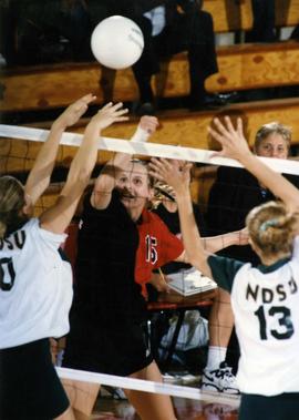 Volleyball player Kim Pellman spikes the ball during a game against the University of North Dakota