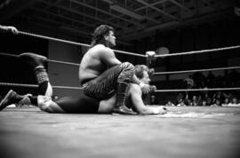 Wrestler Paul Diamond holds the head of Ricky Rice during a match at the Sauk Rapids High School