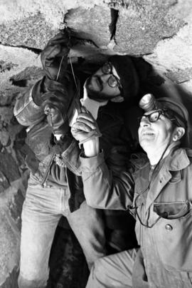 Dave Mork and Harry Goehring look for bats in a sewer, St. Cloud State University