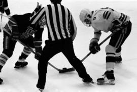 Hockey player Mike Turgeon takes a face off against University of Wisconsin - Eau Claire, St. Cloud State University