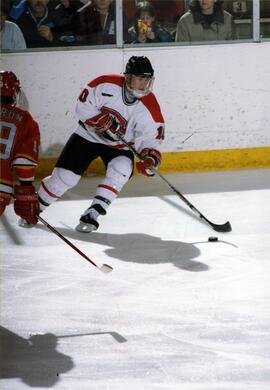 Hockey player Matt Bailey handles the hockey puck during a game, St. Cloud State University