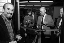 Brendan McDonald cuts a ribbon at KVSC studios while Al Neff and Dick Hill look on, St. Cloud State University