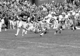 Football player Dan Neubauer runs with the ball after an interception against the University of Minnesota-Duluth, St. Cloud State University