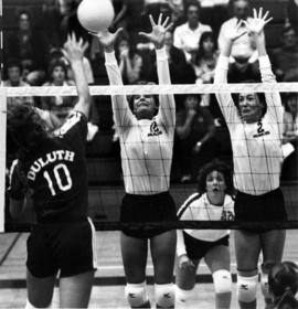 St. Cloud State volleyball players Dorene DeChanie and Kim Thiesfeld block a shot against the University of Minnesota-Duluth