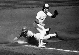 St. Cloud State University baseball players slides into third base