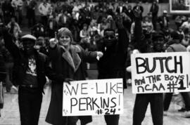 Spectators show off signs in support of the St. Cloud State University basketball team