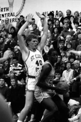 Basketball player Troy Rudoll blocks an oppnent player during a basketball game against St. John's University, St. Cloud State University