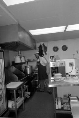 Man works in kitchen at Bravo Burritos