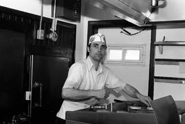 Dave Henning works the grill at Val's Rapid Serve